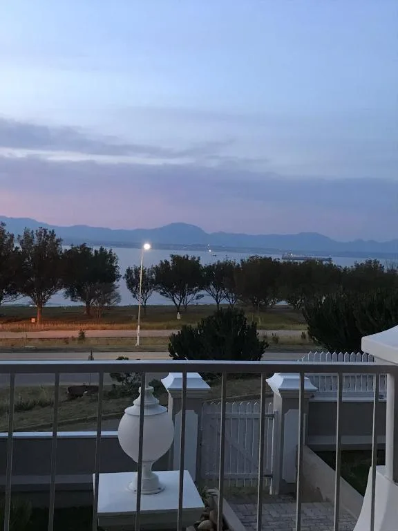 Mossel Bay lagoon at dusk with mountains and lit pathways visible
