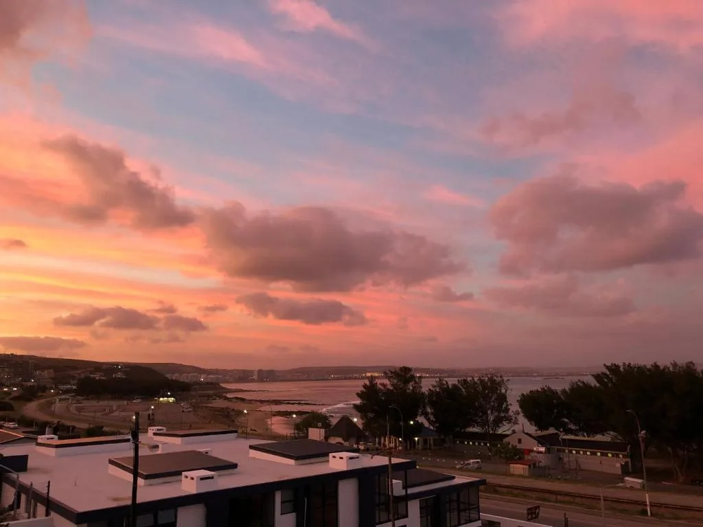 Sunset over Mossel Bay lagoon with pink sky and coastal landscape