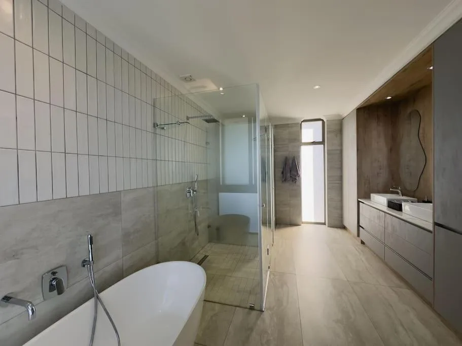 Modern bathroom with freestanding bathtub and walk-in shower enclosure
