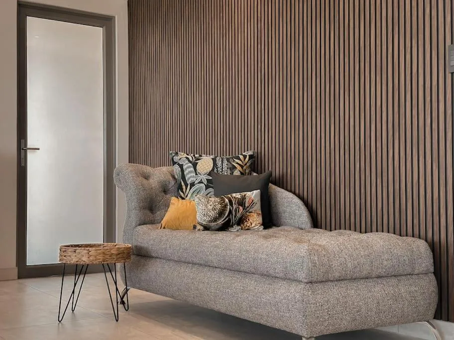 Modern bedroom with gray upholstered bed and decorative pillows