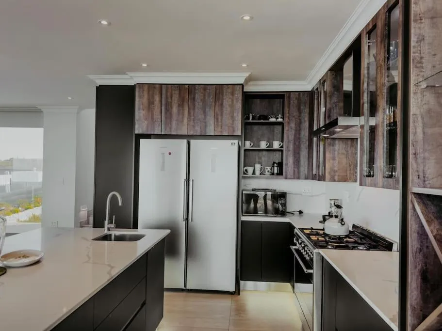 Modern kitchen with stainless steel appliances and white countertops