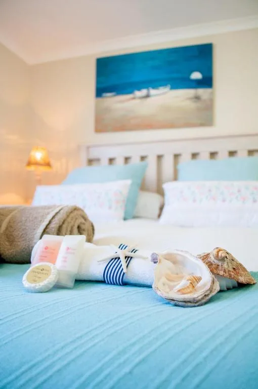 Coastal-themed bedroom with beach amenities and ocean artwork displayed