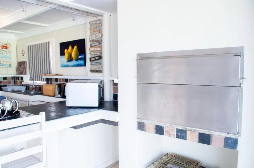 Modern kitchen with stainless steel appliances and open-plan living space