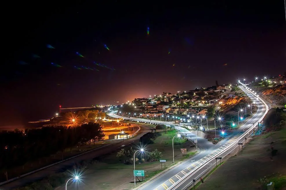 Nighttime aerial view of Mossel Bay coastal town with illuminated streets