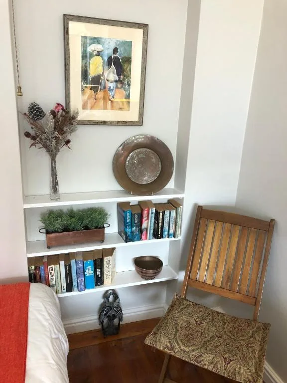 Built-in shelving unit with books, artwork, plants, and decorative items