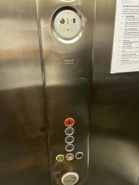Close-up of modern elevator control panel with illuminated floor buttons