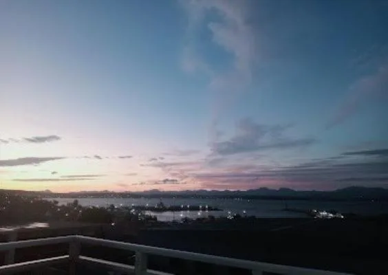 Sunset over Mossel Bay lagoon with mountains silhouetted against pink sky
