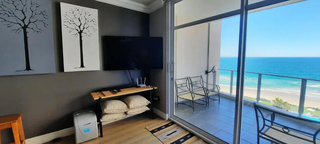 Modern bedroom with ocean view through large sliding glass doors