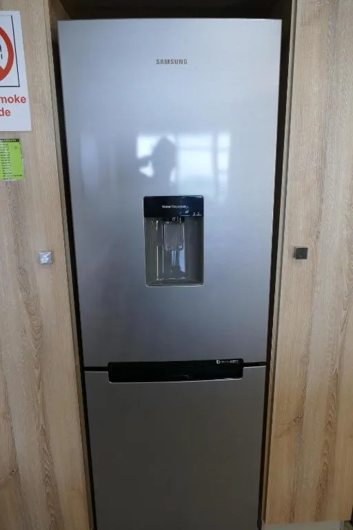 Modern Samsung refrigerator with ice and water dispenser in kitchen