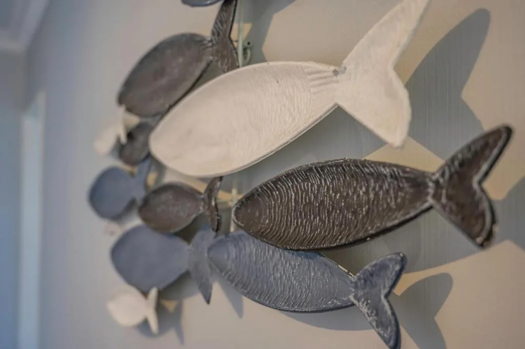 Decorative fish-shaped ornaments hanging from ceiling in neutral tones