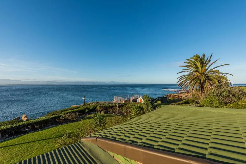 Scenic ocean and coastline vista from property with palm trees