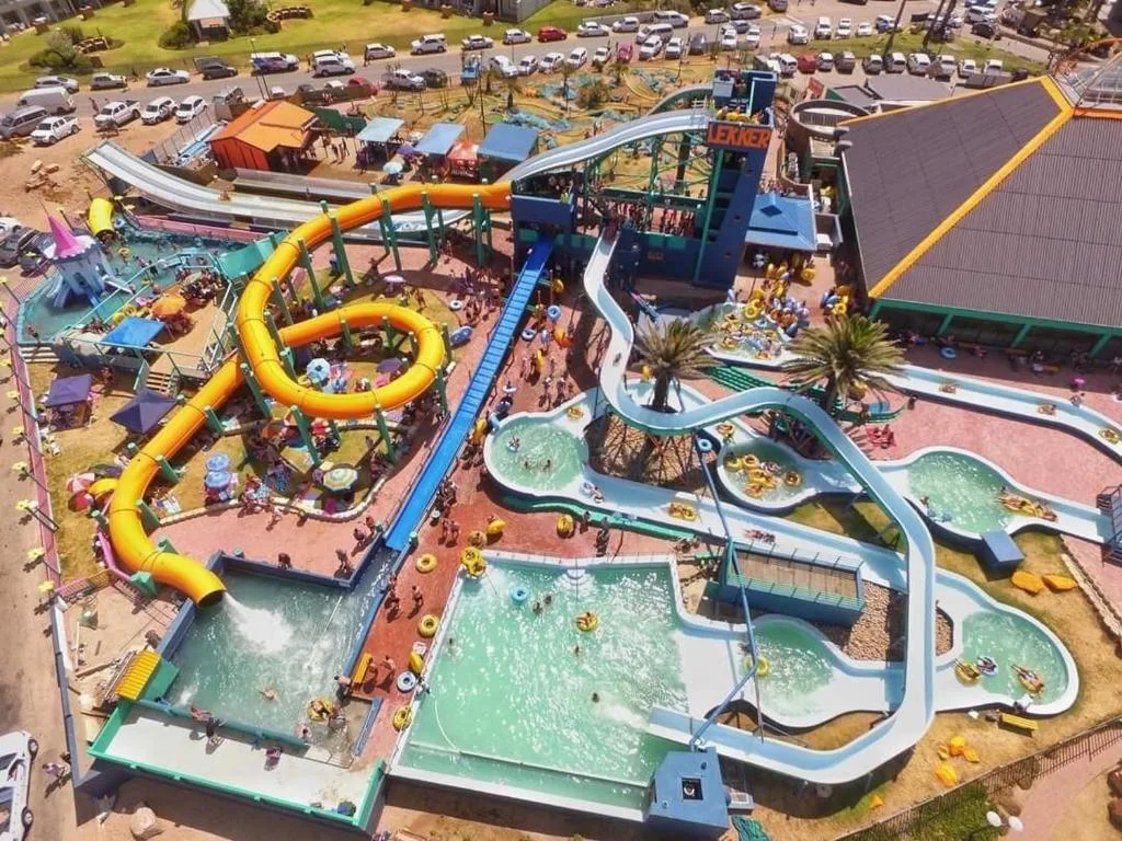 Aerial view of nearby water park with colorful slides and pools