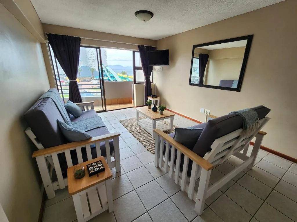Spacious lounge with ocean views, comfortable seating, and balcony access