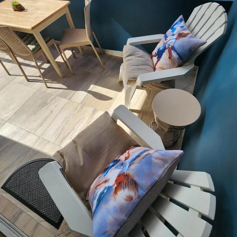 Outdoor patio seating area with comfortable lounge chairs and side table