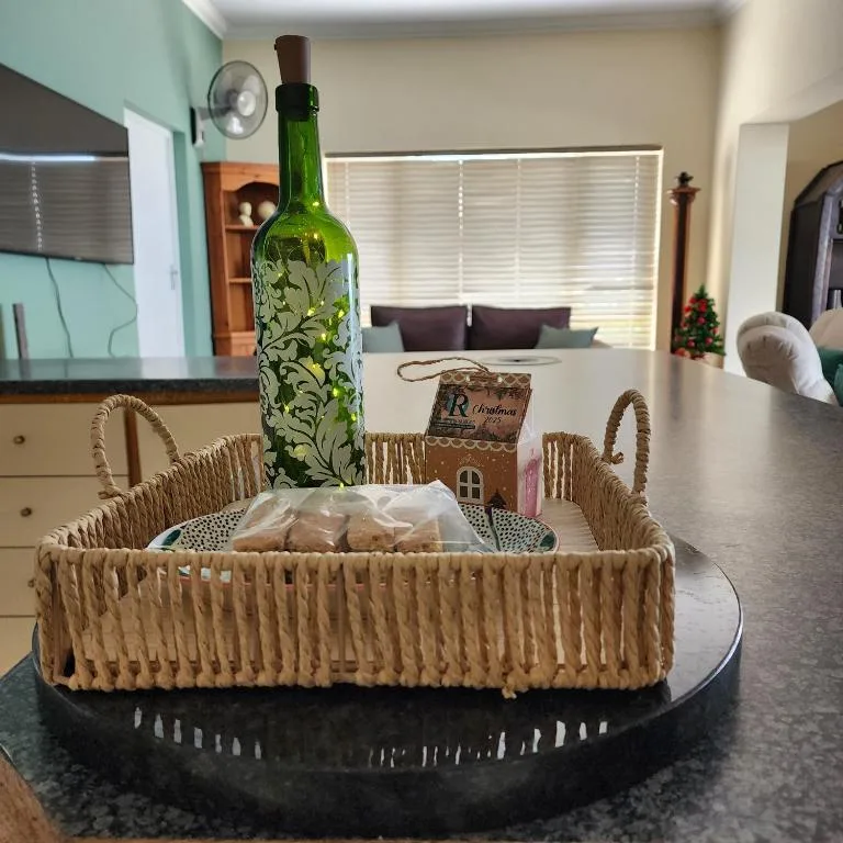 Decorative welcome basket with wine bottle and festive ornaments on kitchen counter