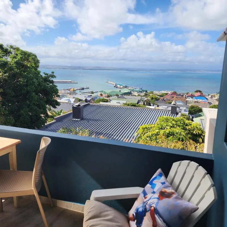 Panoramic coastal view from deck overlooking Mossel Bay harbor and ocean