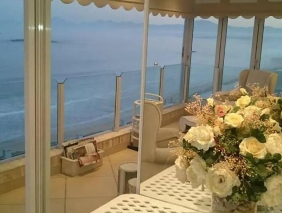 Panoramic ocean and coastline views through floor-to-ceiling windows from indoor space