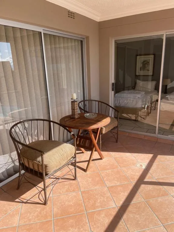 Spacious patio with comfortable seating and sliding doors to bedroom