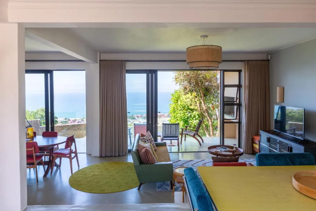 Spacious lounge with ocean views, modern furnishings, and open-plan layout