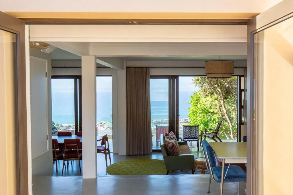 Modern lounge with ocean views, contemporary furniture, and open-plan layout