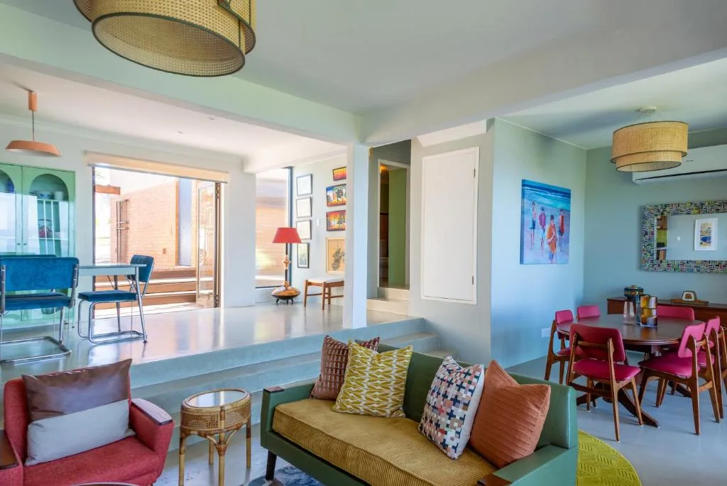 Bright open-plan lounge with colorful seating and modern furnishings