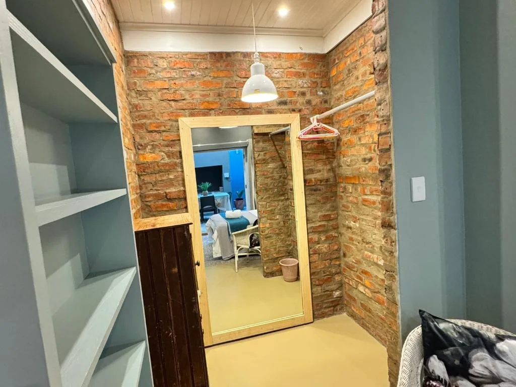 Modern hallway with exposed brick walls and pendant lighting fixture