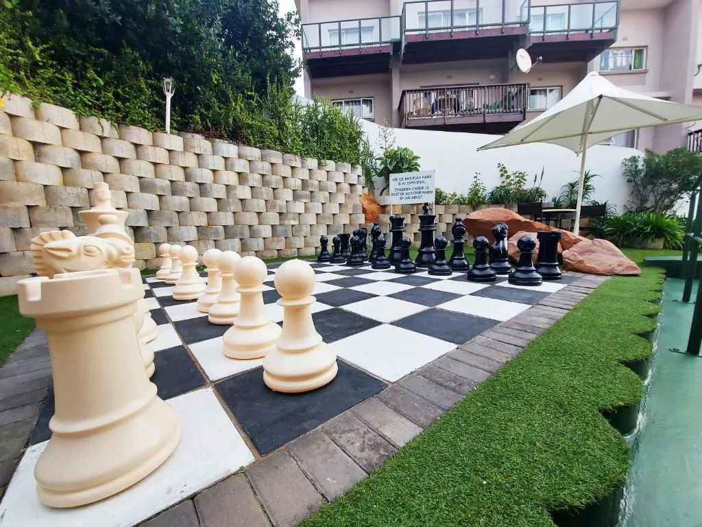 Outdoor patio with giant chess board and landscaped garden seating area