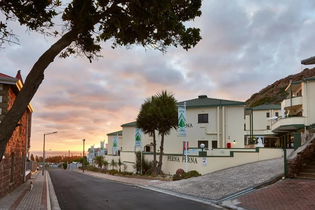 White apartment buildings with green roofs at sunset on Garden Route