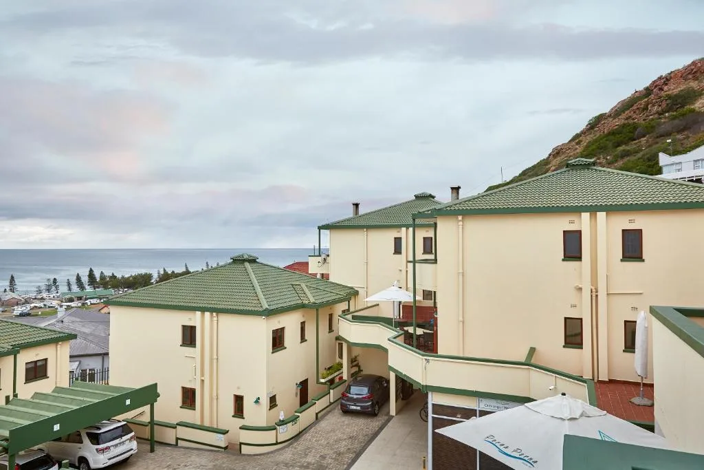 Multi-unit cream and green residential building complex with ocean view
