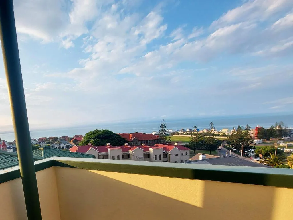 Panoramic coastal town view with ocean horizon and residential buildings