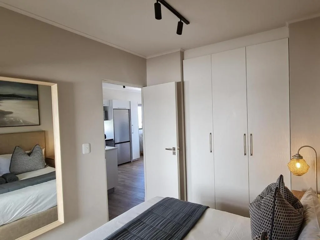 Modern bedroom with built-in wardrobes and ensuite bathroom access