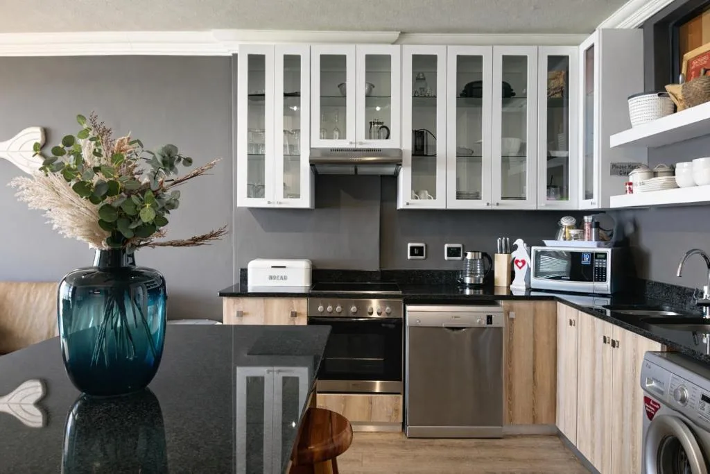 Modern kitchen with stainless steel appliances and white cabinetry