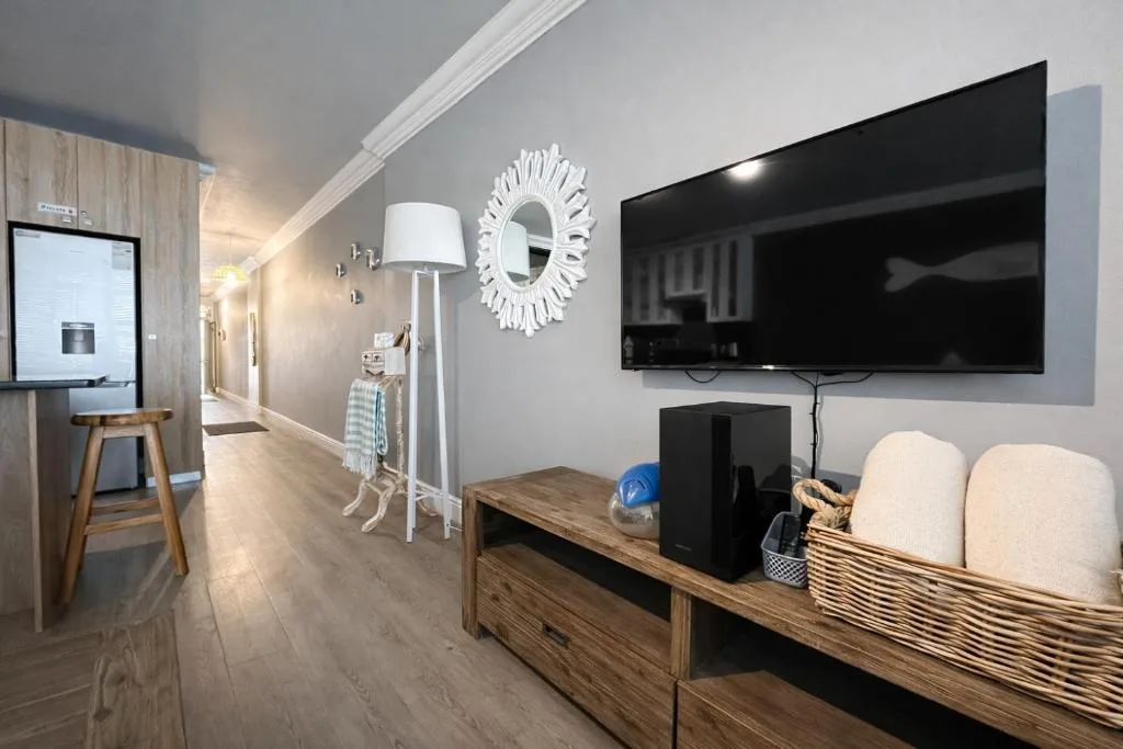 Modern living room with TV, wooden media unit, and contemporary decor