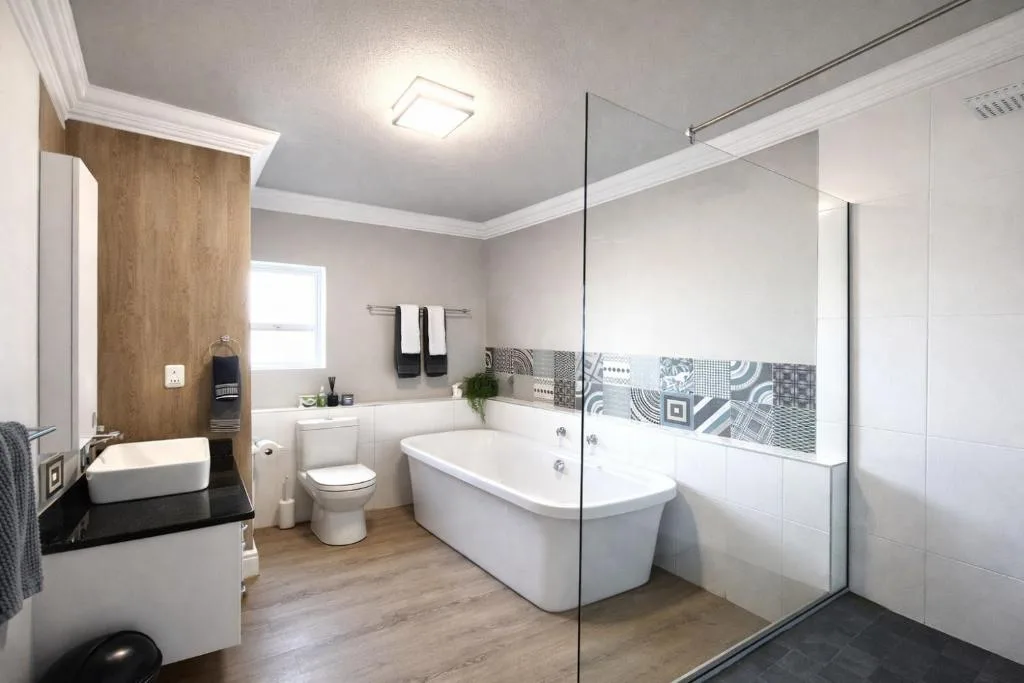 Modern bathroom with freestanding tub, walk-in shower, and double vanity