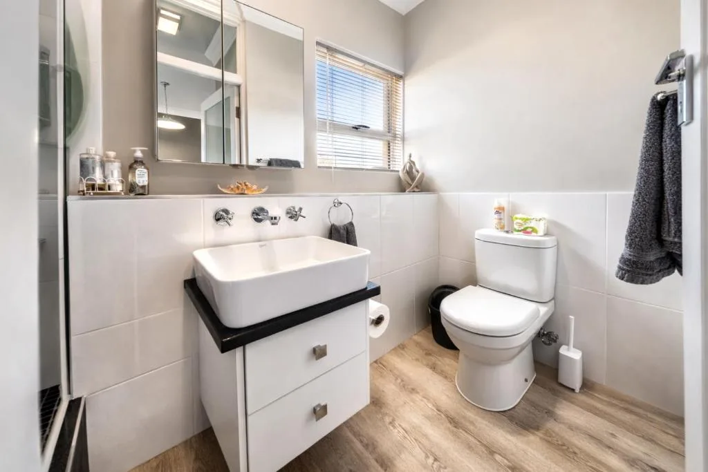 Modern bathroom with white rectangular basin sink and toilet fixtures
