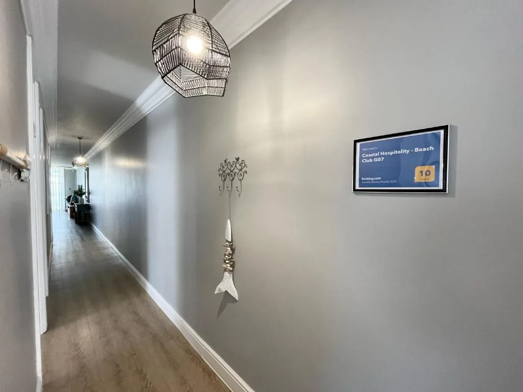 Modern hallway with woven pendant light and coastal decor accents