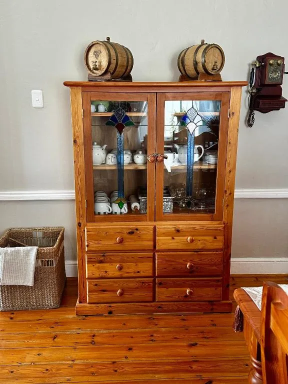 Wooden display cabinet with wine barrels and decorative pottery collection