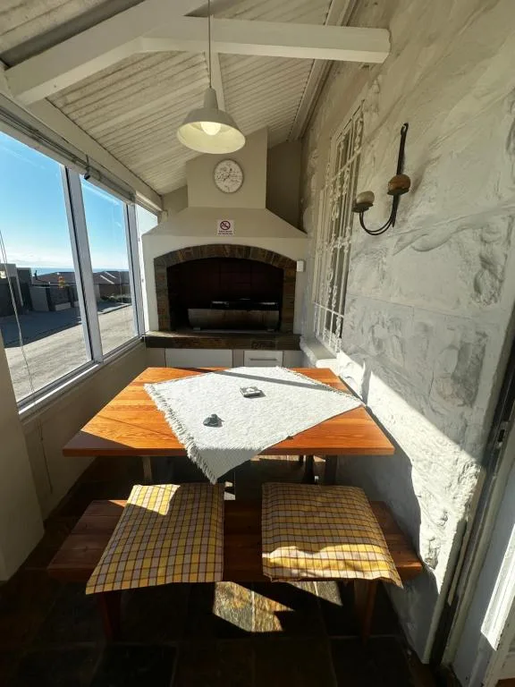 Wooden dining table with benches in bright sunlit room