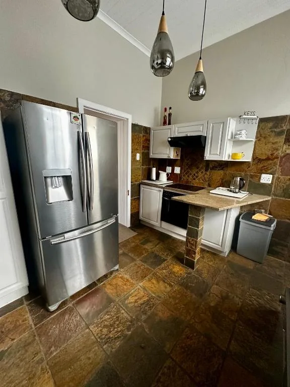 Modern kitchen with stainless steel appliances and tiled countertops