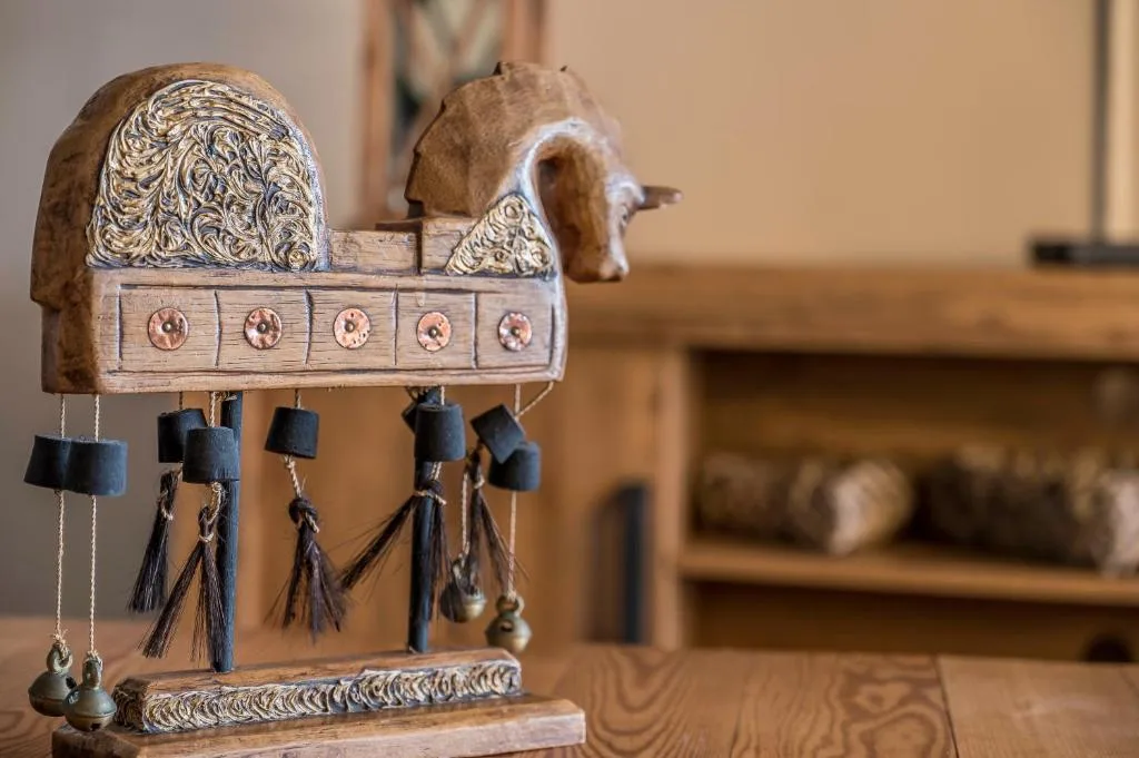 Wooden decorative wind chime with carved details and hanging bells