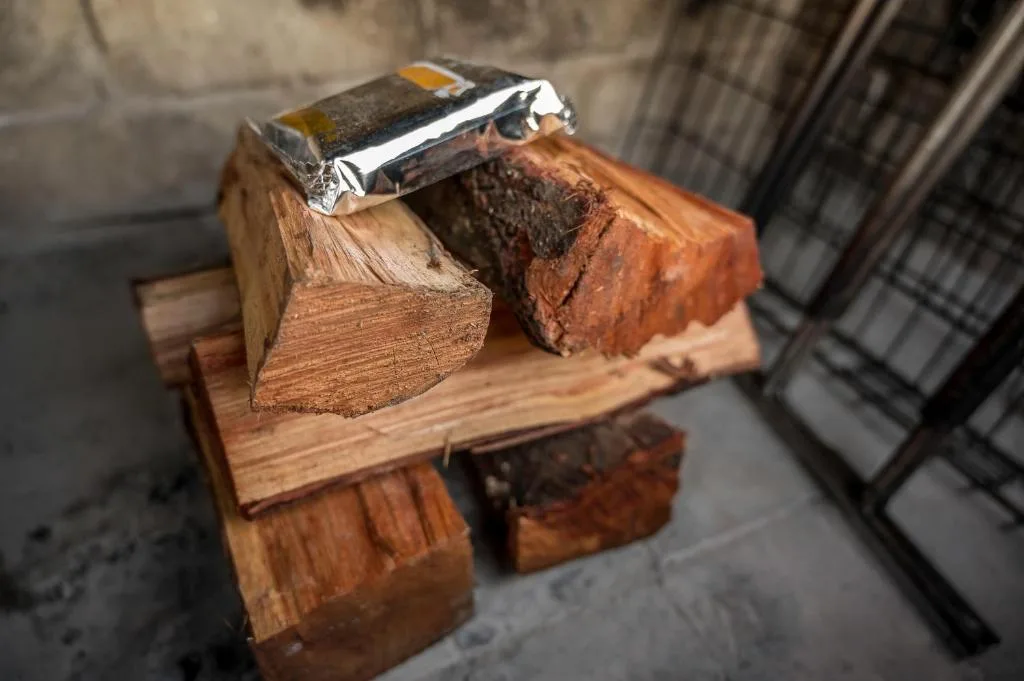 Firewood and matches arranged on rustic wooden holder