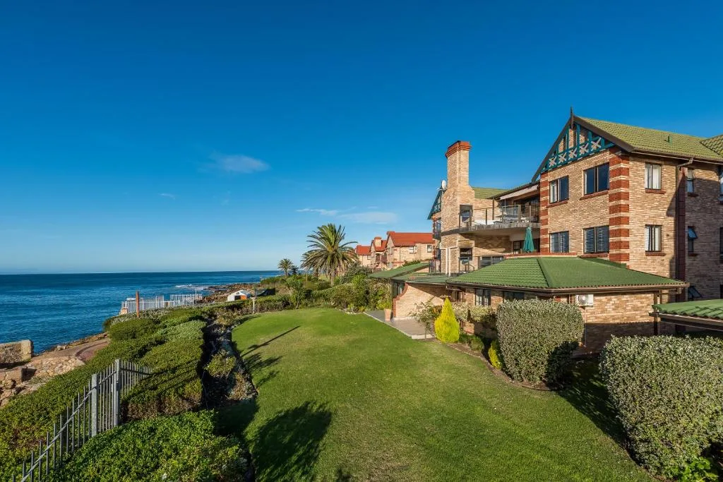 Victorian brick mansion with manicured gardens overlooking the ocean on Garden Route