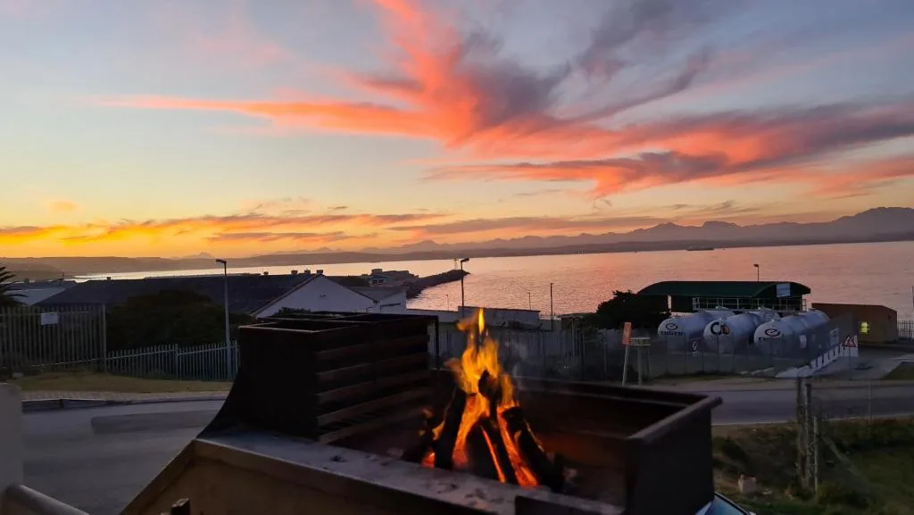 Braai fire pit with sunset view over lagoon and mountains