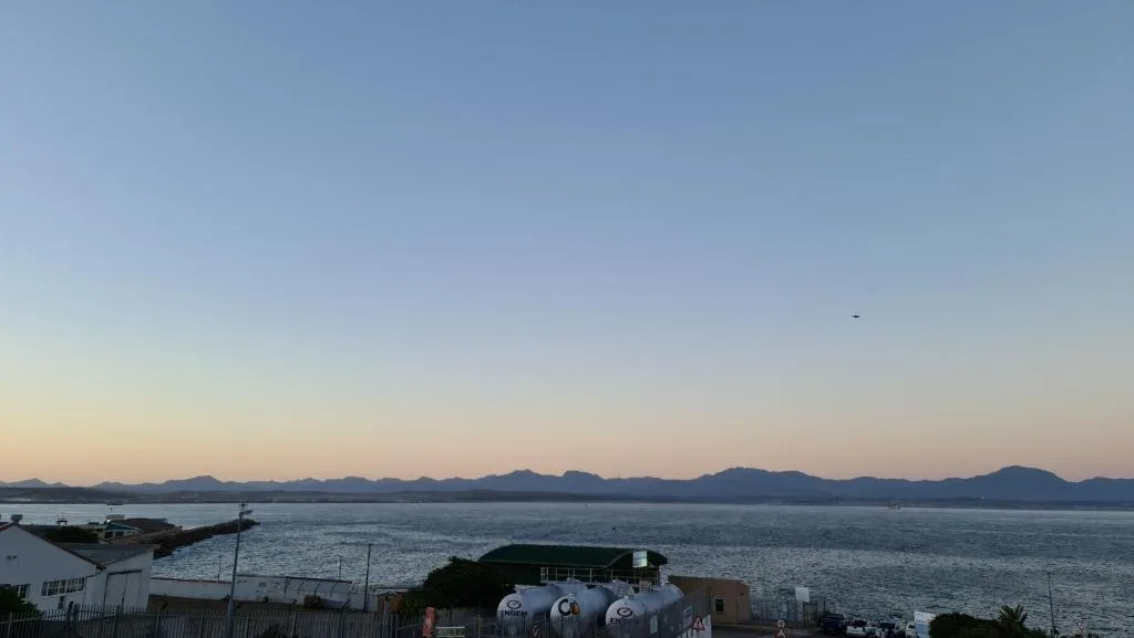 Panoramic coastal view of Mossel Bay with distant mountains and calm waters