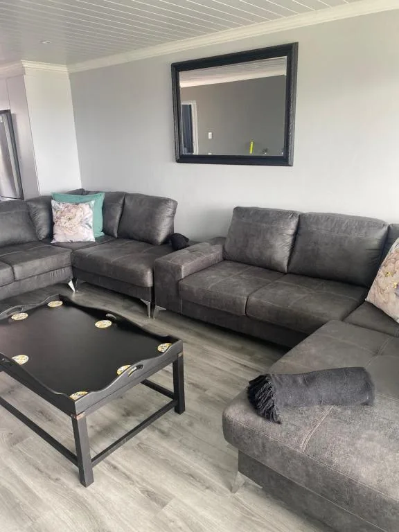 Modern lounge with gray leather sofas and black coffee table