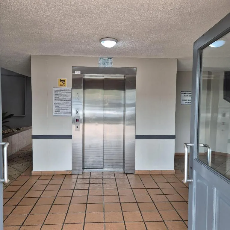 Building elevator and entrance hallway with terracotta tiling