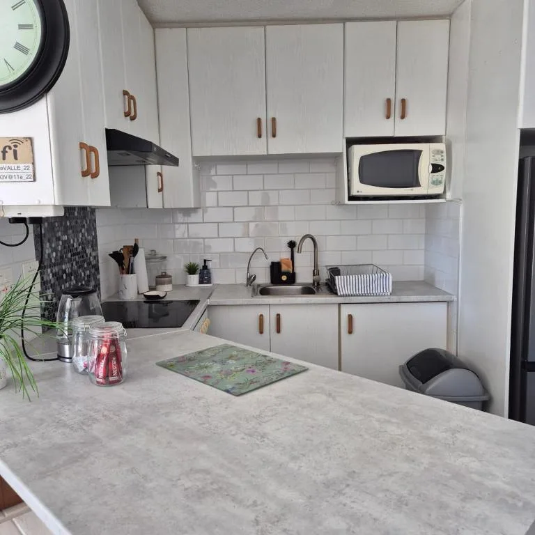 Modern kitchen with white cabinets, subway tile backsplash, and stainless steel sink