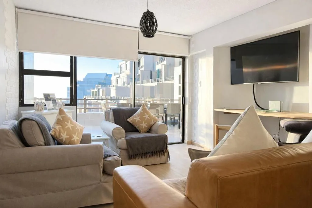 Modern lounge with comfortable seating and large windows overlooking the coast