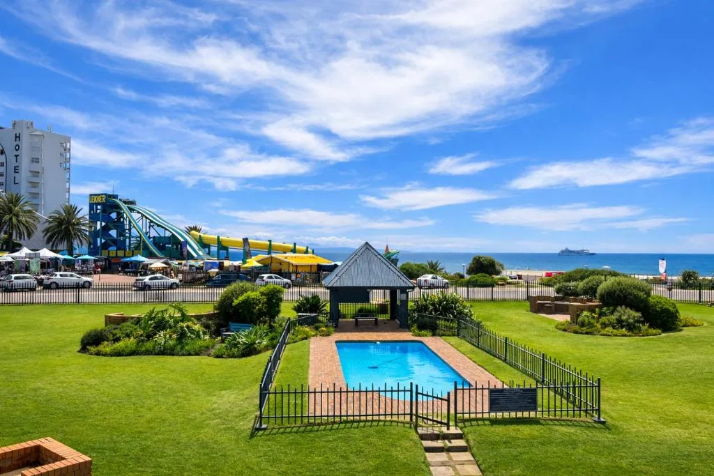 Beachfront property with pool, manicured gardens, and Indian Ocean views