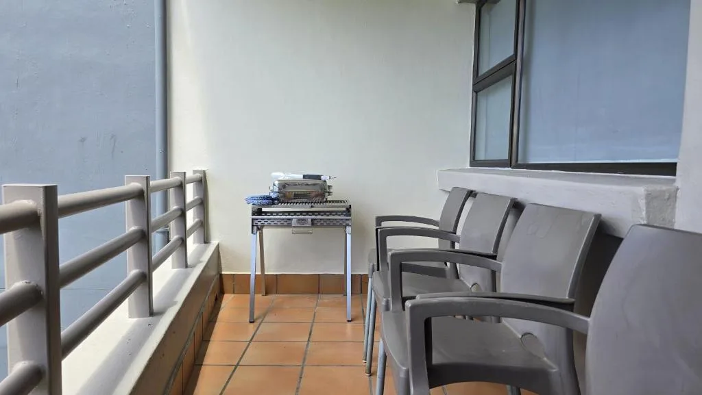 Outdoor balcony with gray seating and braai area overlooking the coast